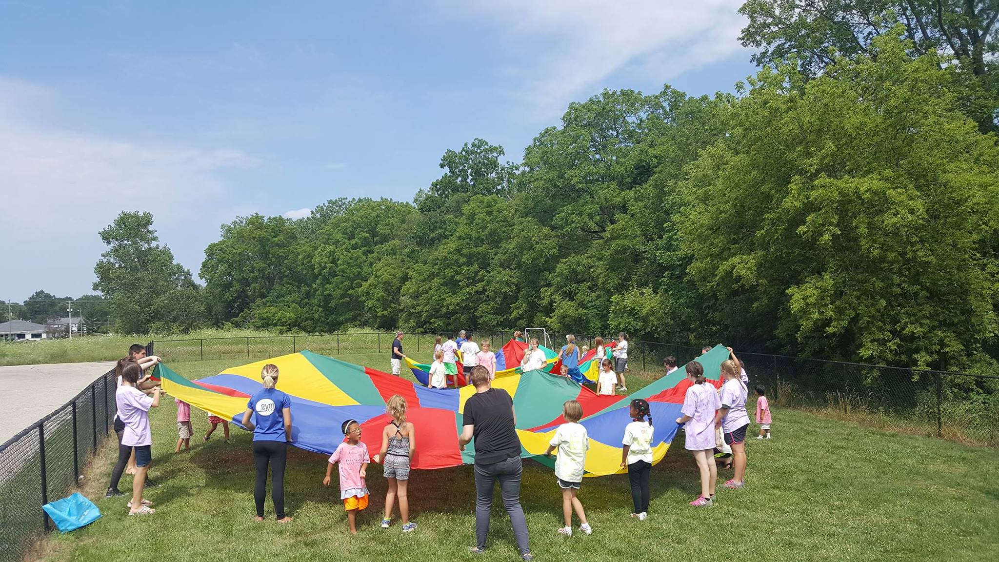 Photo of children play with parachute outdoors