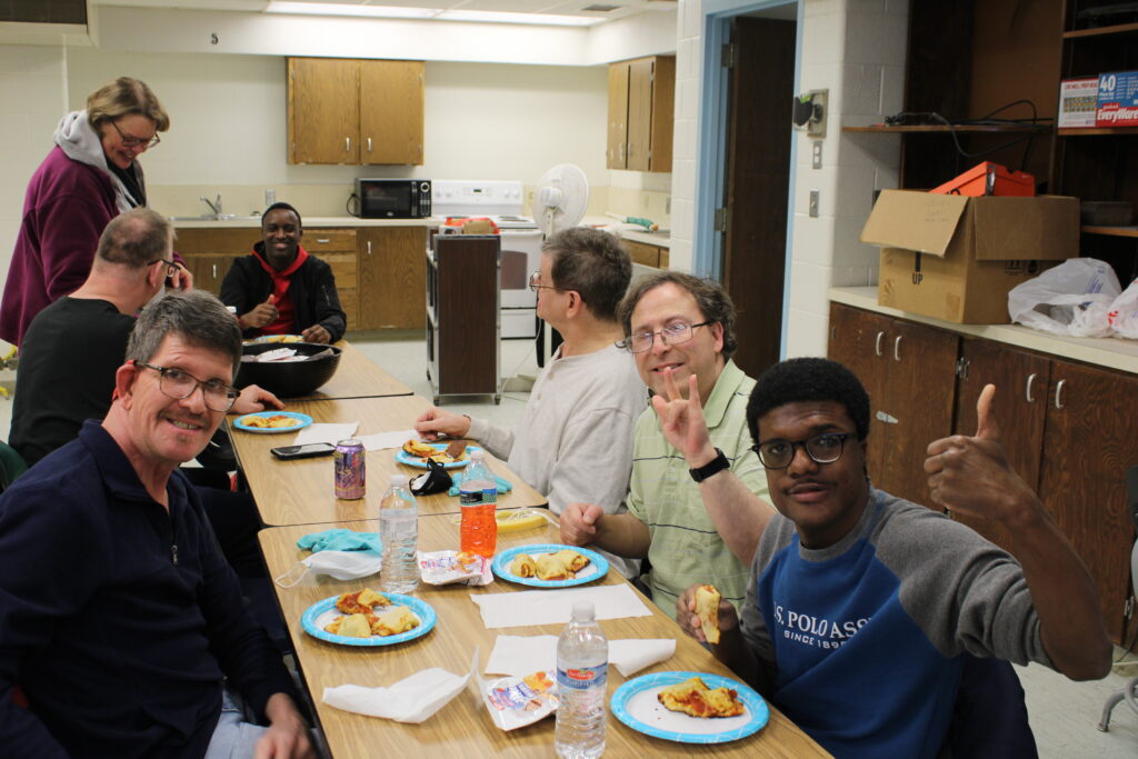 Group members sat around a table with lunch