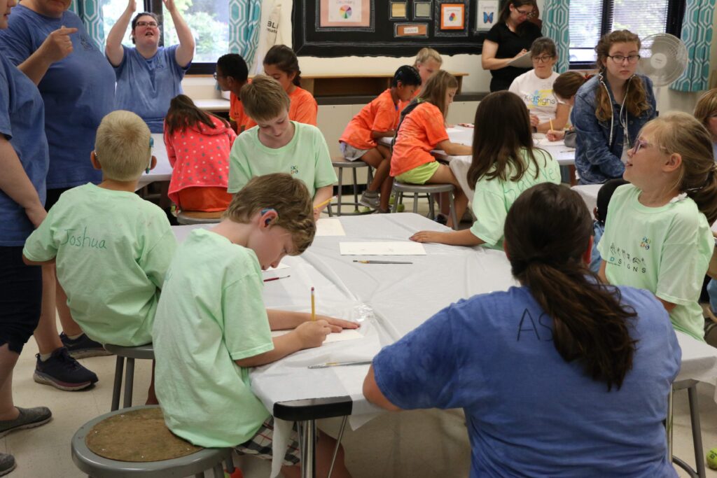 Children sitting around a table doing art