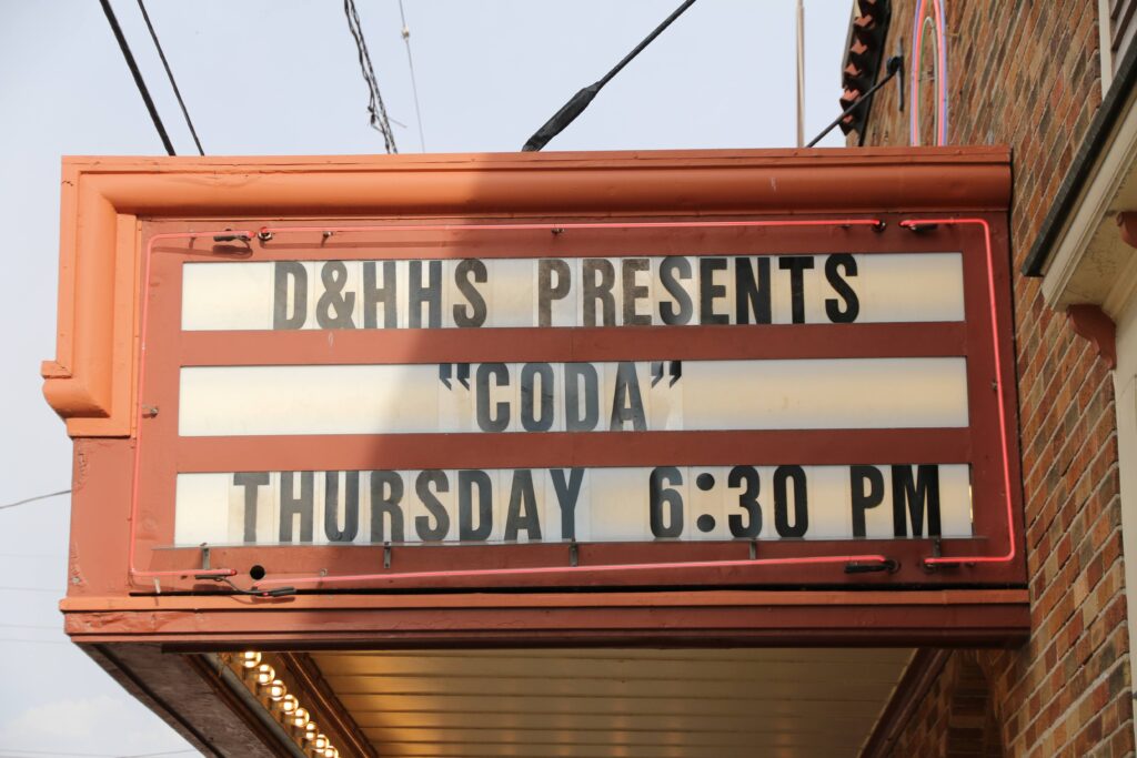 Wealthy theatre marquee reads: D&HHS Presents "CODA" Thursday 6:30 PM