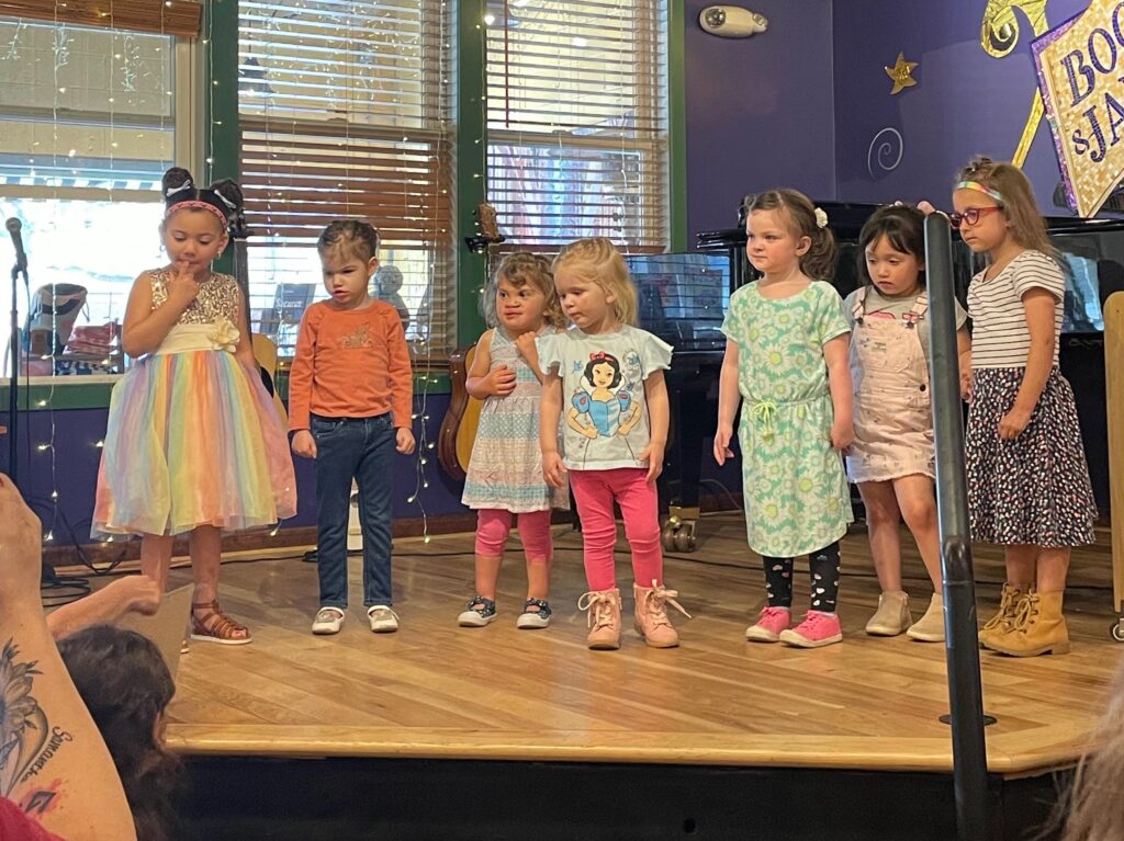 Young children standing together on a stage