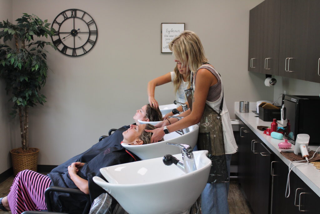 Two women getting their scalps messaged at a spa