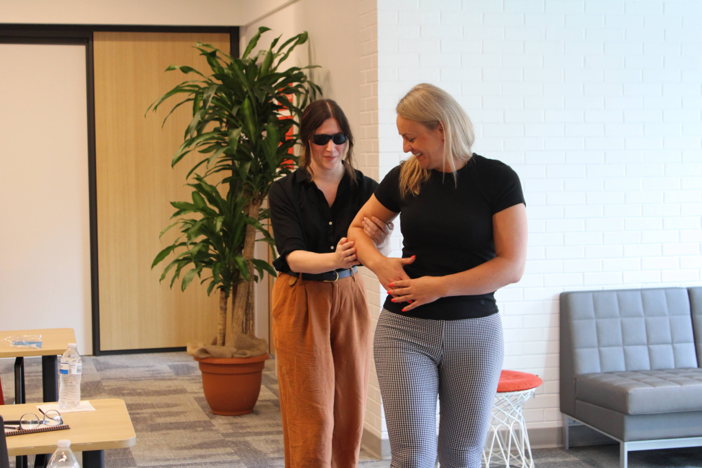 two attendees practice human guide