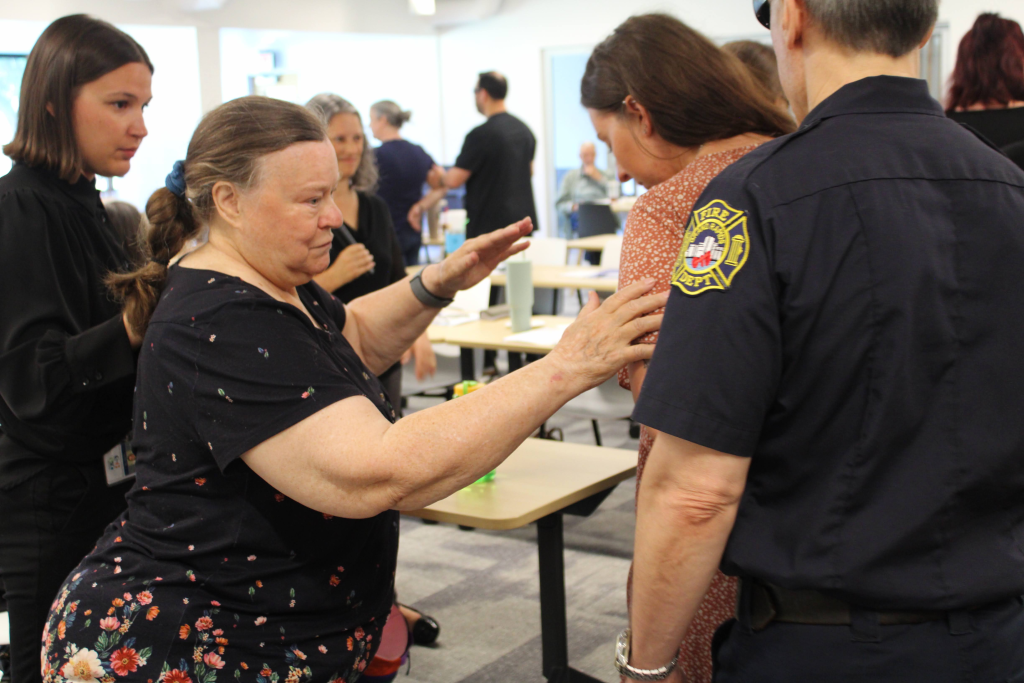 Presenter Izzy reaches out to guide attendees