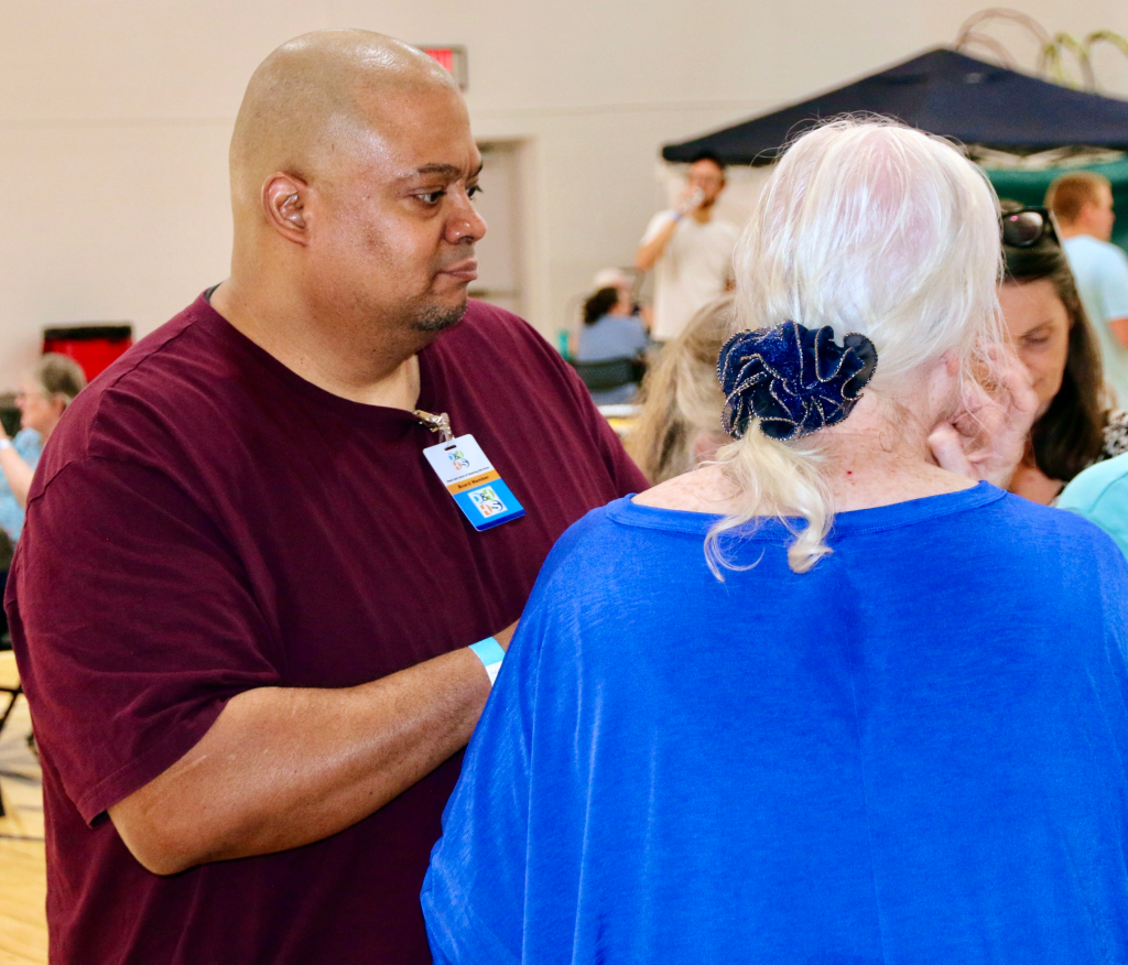 board member Luis Pena talking with community members